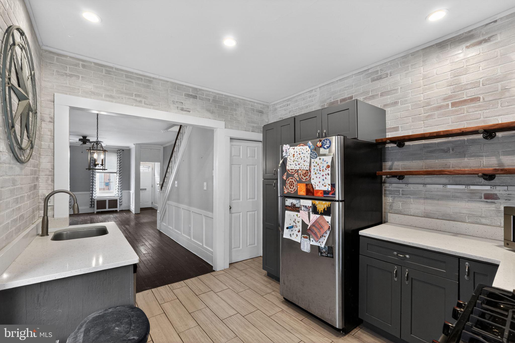 137 Davis Street Philadelphia, PA 19127 - Photo 12 of 17 a kitchen with stainless steel appliances a refrigerator and cabinets