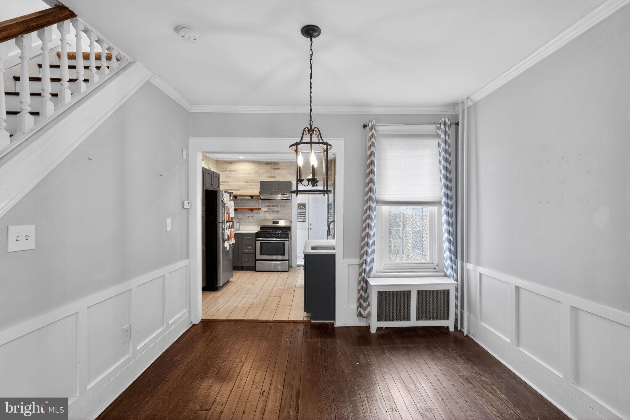 137 Davis Street Philadelphia, PA 19127 - Photo 3 of 17 a view of a hallway with wooden floor windows and a chandelier