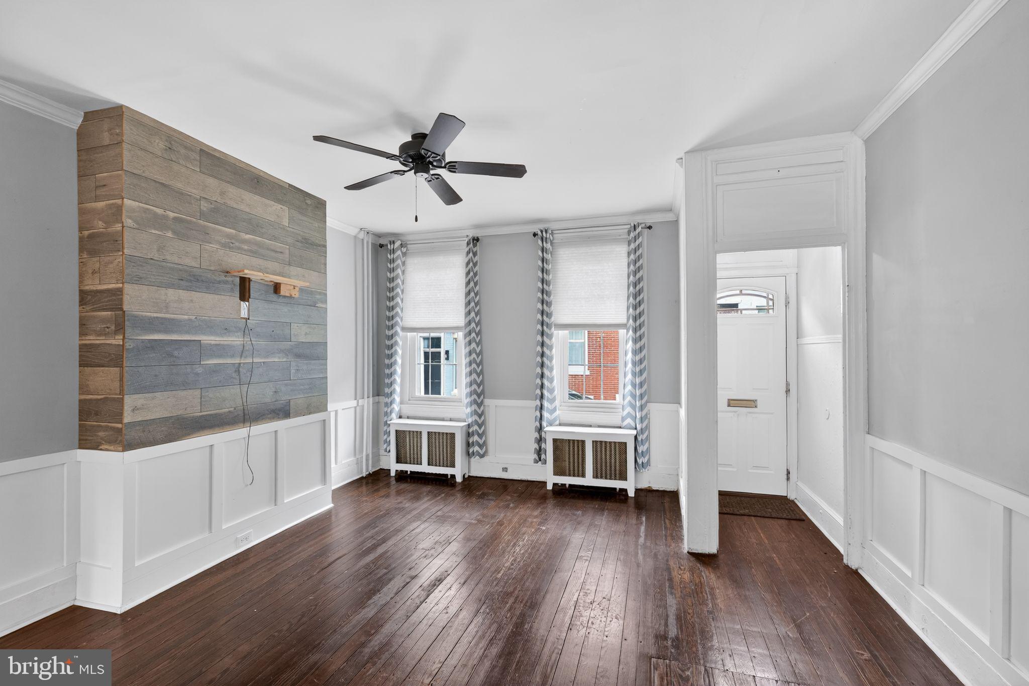 137 Davis Street Philadelphia, PA 19127 - Photo 4 of 17 a view of empty room with wooden floor and window