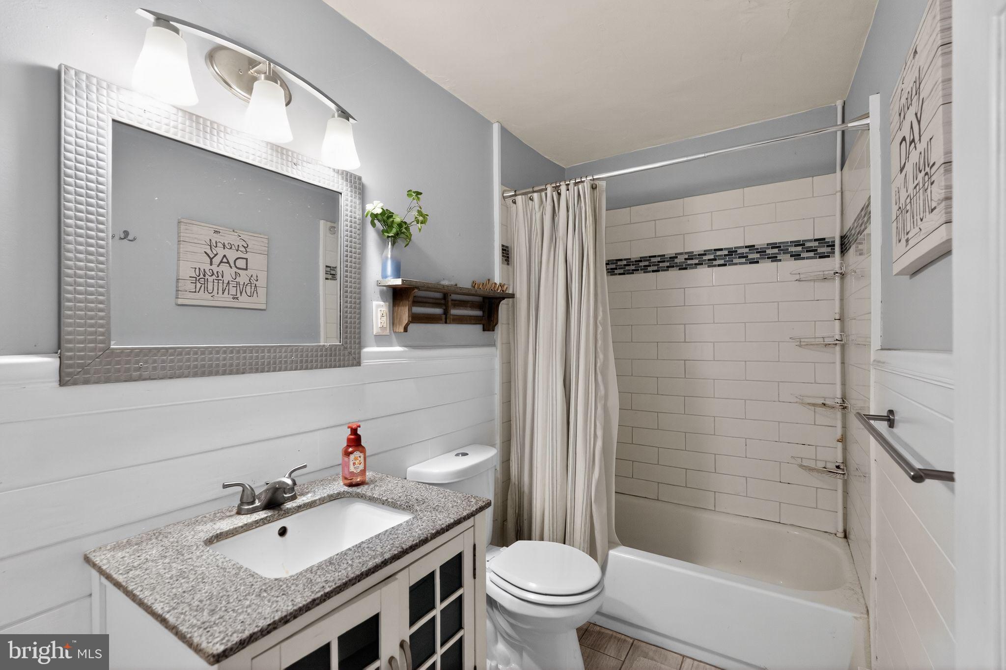 137 Davis Street Philadelphia, PA 19127 - Photo 7 of 17 a bathroom with a granite countertop sink toilet and shower