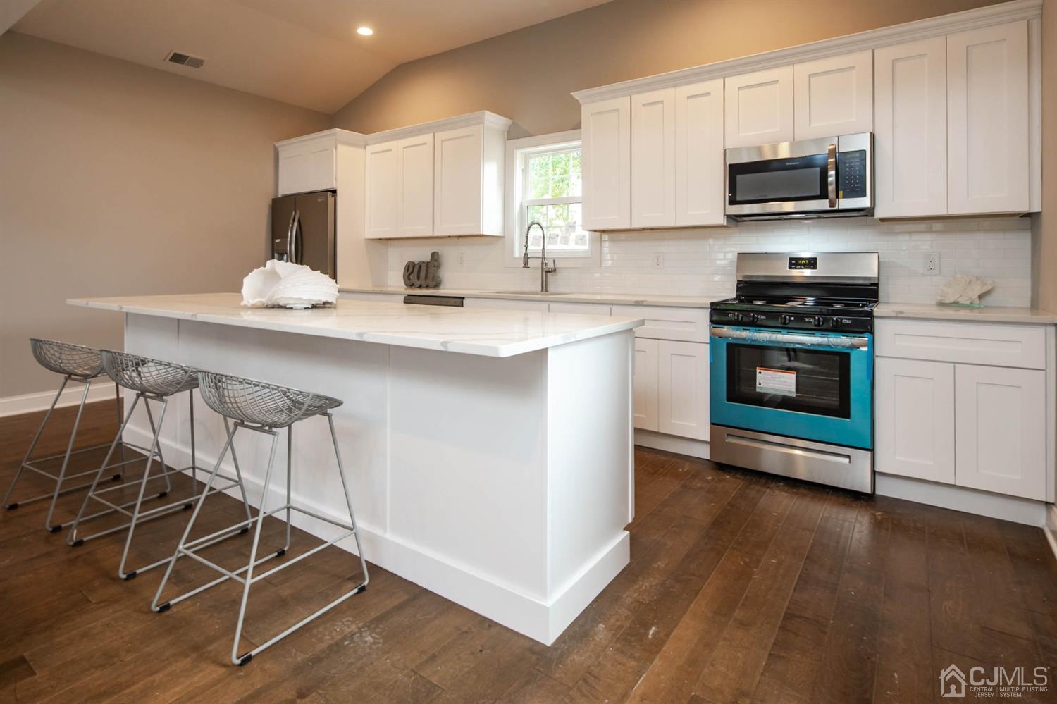 84 Ashley Road Edison, NJ 08817 - Photo 3 of 27 a kitchen with stainless steel appliances a stove a sink and a microwave
