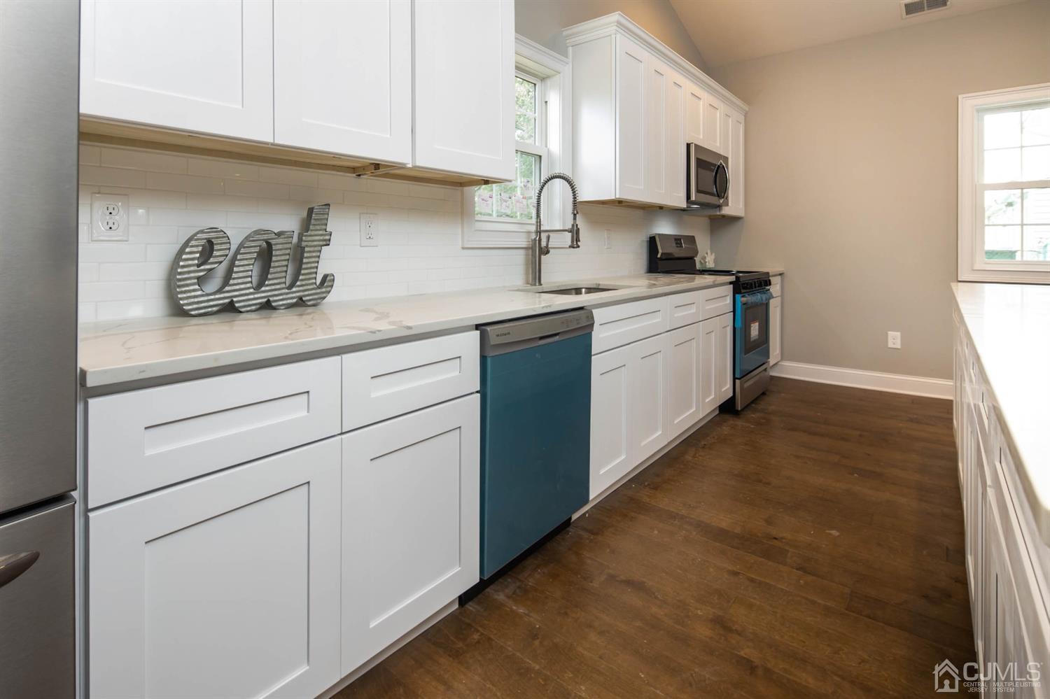 84 Ashley Road Edison, NJ 08817 - Photo 4 of 27 a kitchen with white cabinets and sink