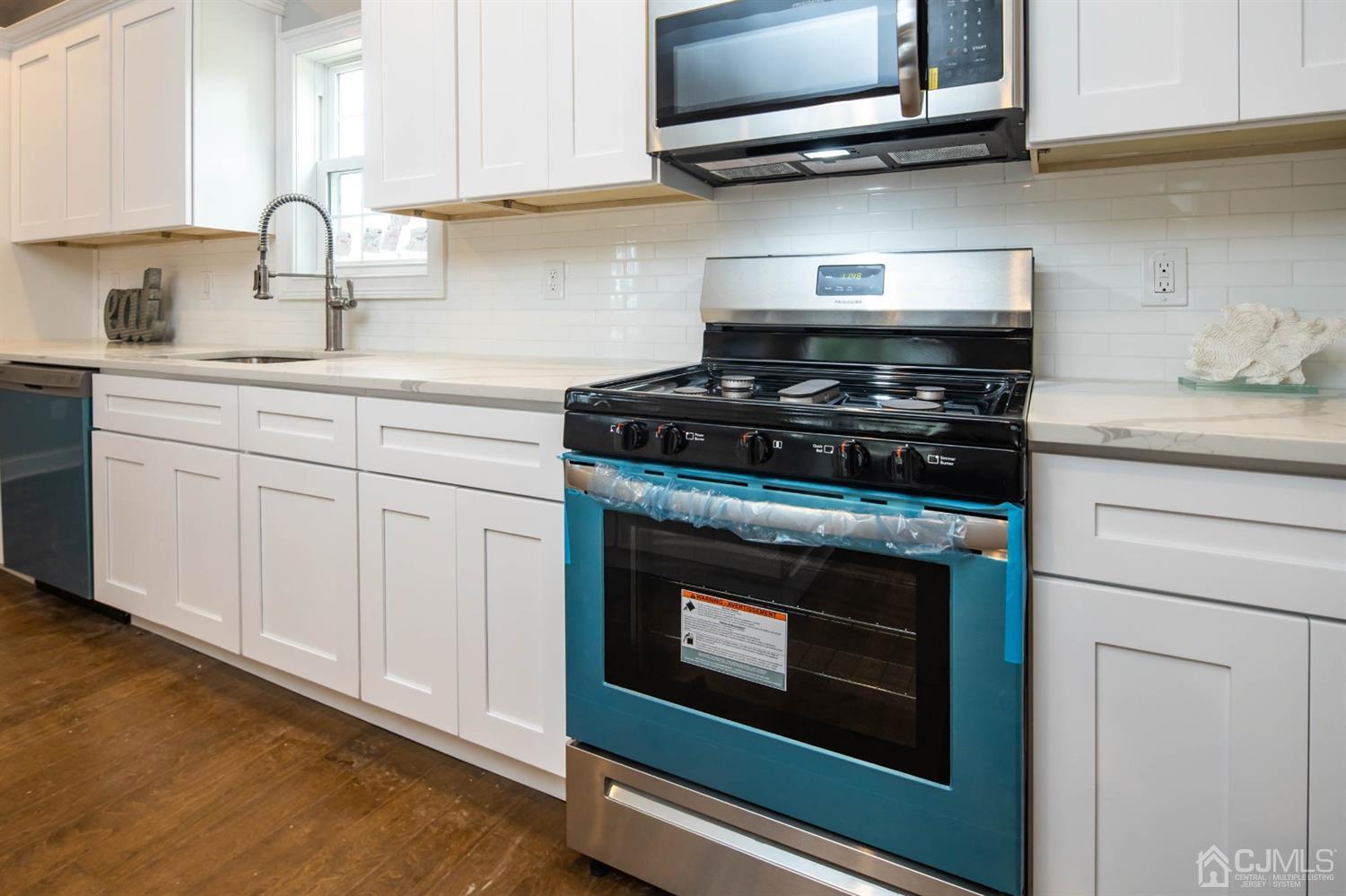 84 Ashley Road Edison, NJ 08817 - Photo 5 of 27 a kitchen with stainless steel appliances granite countertop a stove and a microwave