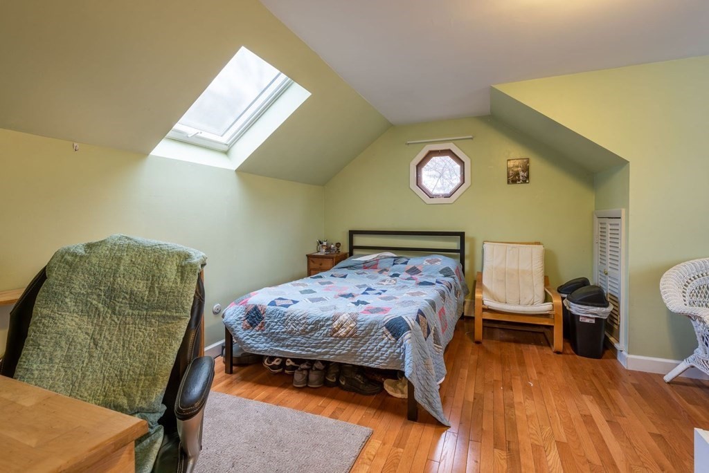 320 Pelham Road Amherst, MA 01002 - Photo 19 of 23 a bedroom with a bed and a lamp on table