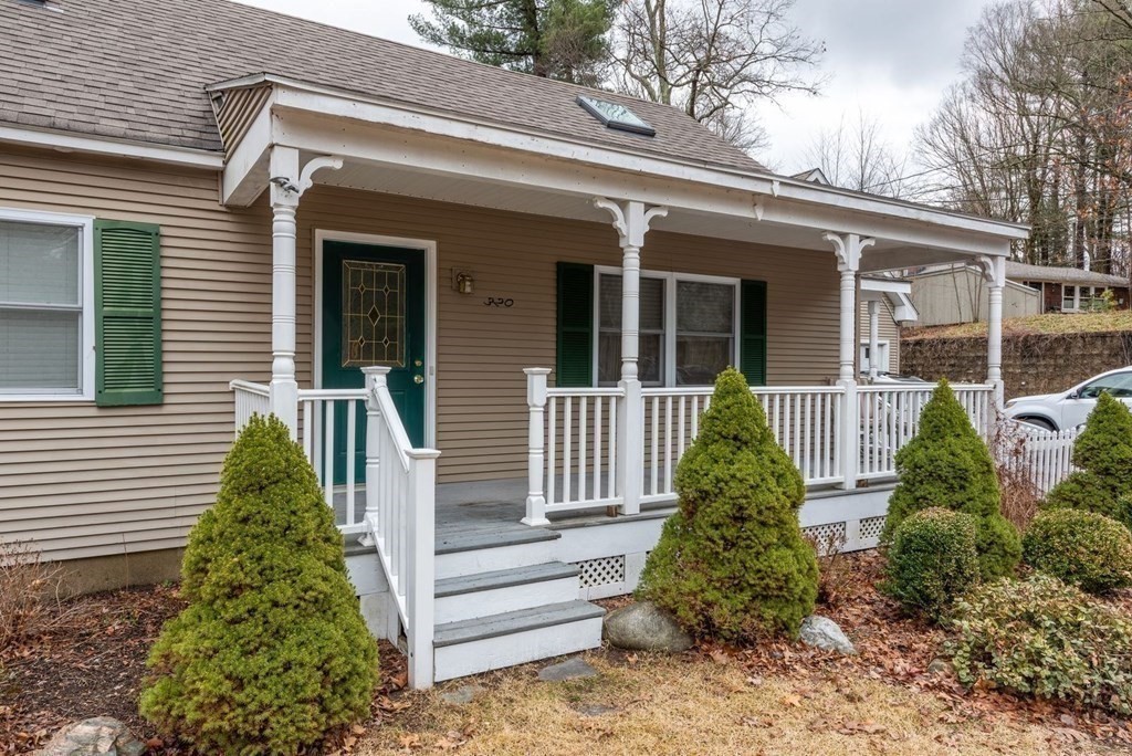 320 Pelham Road Amherst, MA 01002 - Photo 5 of 23 a view of a house with brick walls and flower plants