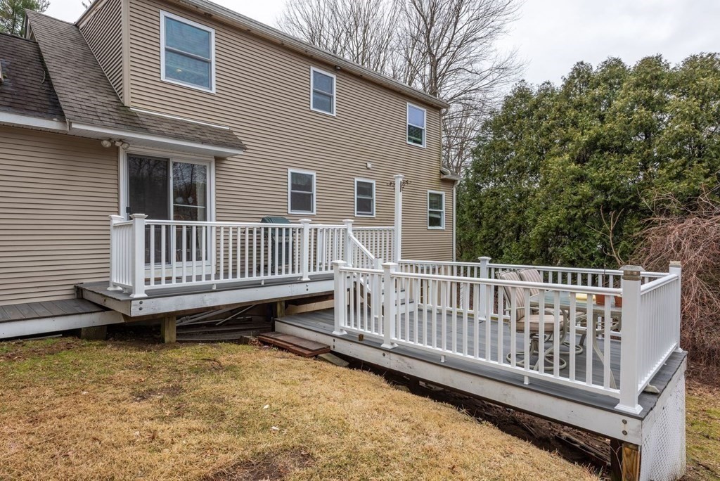 320 Pelham Road Amherst, MA 01002 - Photo 6 of 23 a view of a deck with a chair and wooden floor