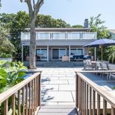 a view of a house with backyard and sitting area