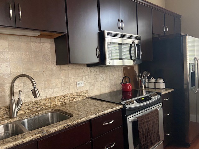 804 North Thompson Lane, Unit 2H Murfreesboro, TN 37129 - Photo 2 of 6 a kitchen with granite countertop a sink stainless steel appliances and cabinets