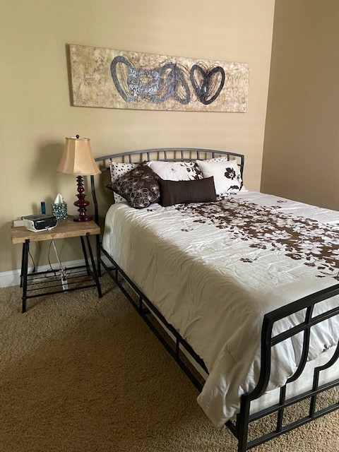 804 North Thompson Lane, Unit 2H Murfreesboro, TN 37129 - Photo 5 of 6 a bedroom with a bed and wooden floor