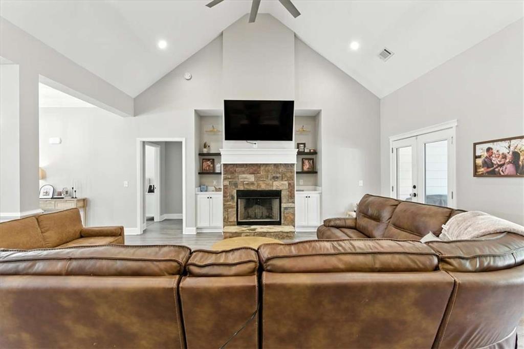 62 Joe Rowell Road Buchanan, GA 30113 - Photo 11 of 63 a living room with furniture a flat screen tv and a fireplace
