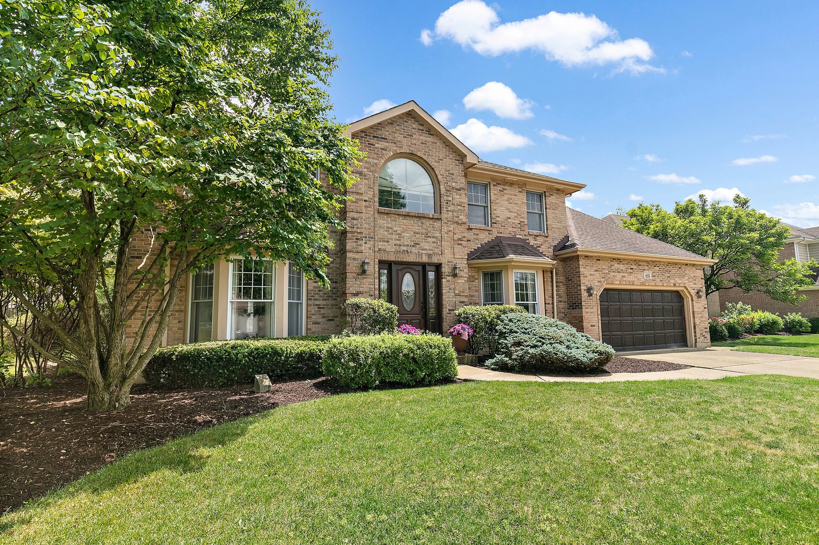 a front view of a house with garden