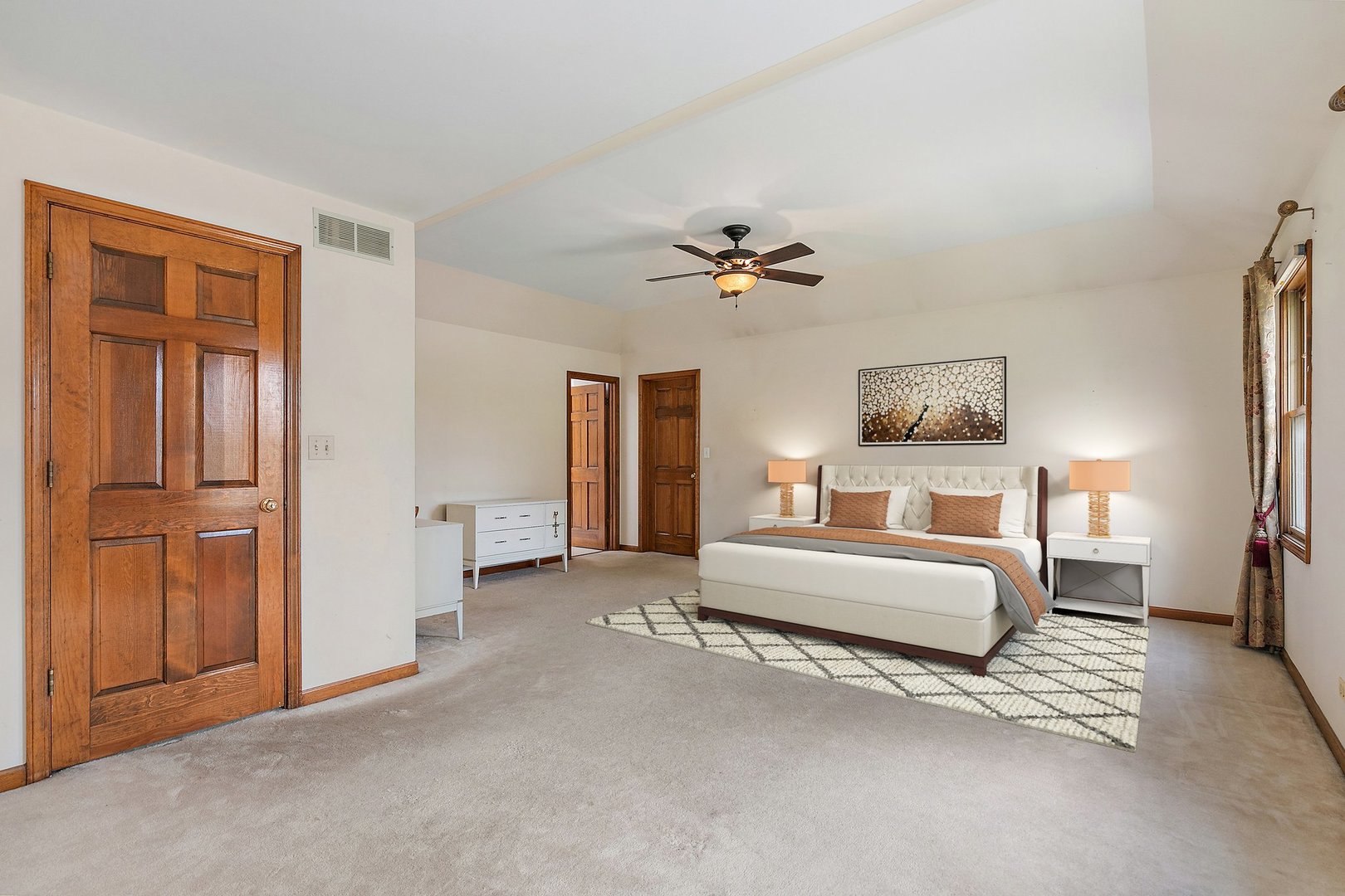 655 Red Maple Lane Roselle, IL 60172 - Photo 16 of 40 a spacious bedroom with a bed and a chandelier