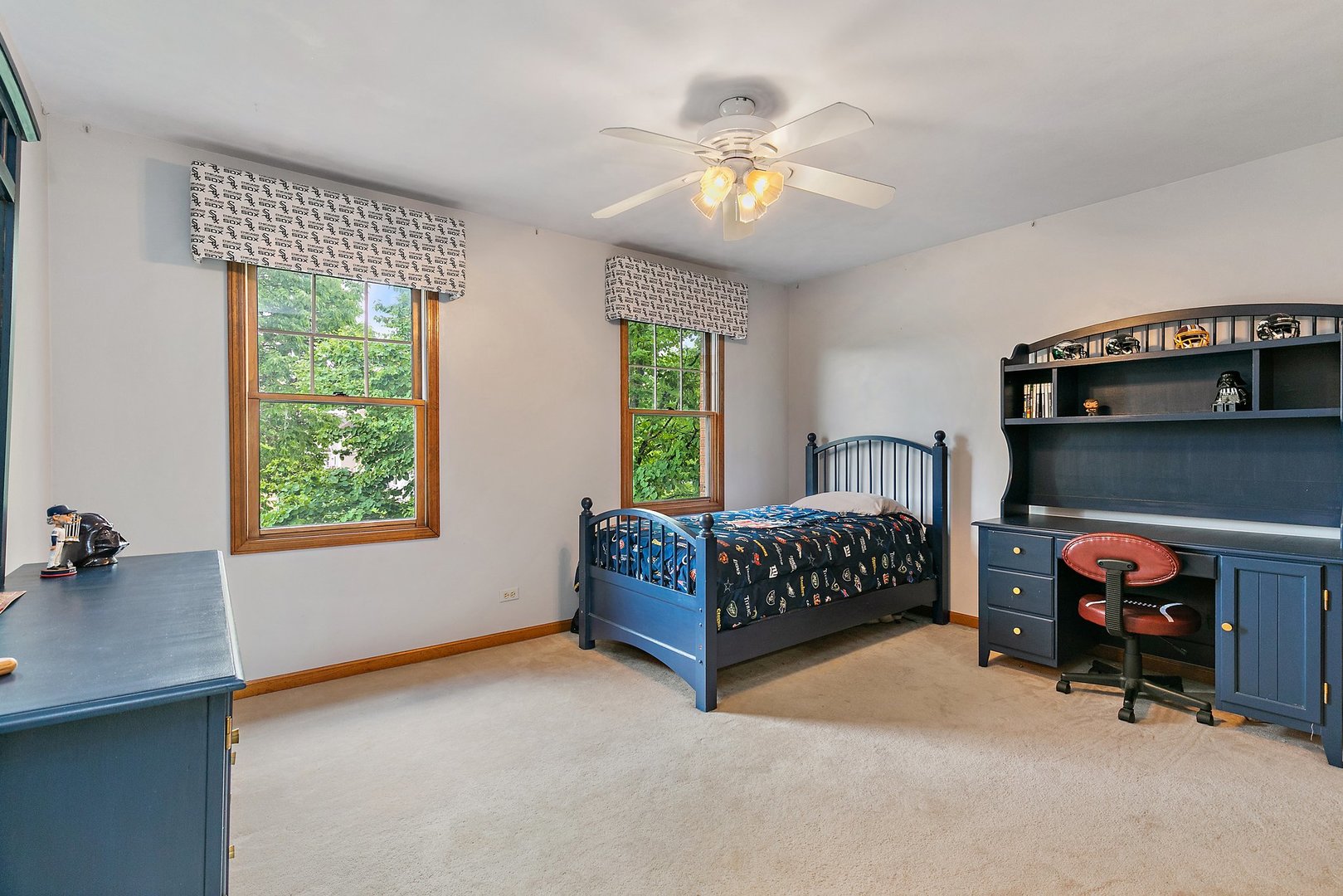 655 Red Maple Lane Roselle, IL 60172 - Photo 23 of 40 a bedroom with a bed and a chandelier