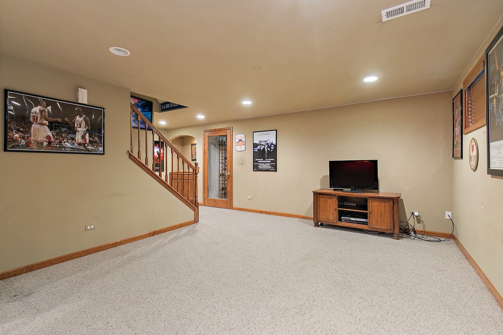 655 Red Maple Lane Roselle, IL 60172 - Photo 26 of 40 a view of a livingroom with furniture and a flat screen tv