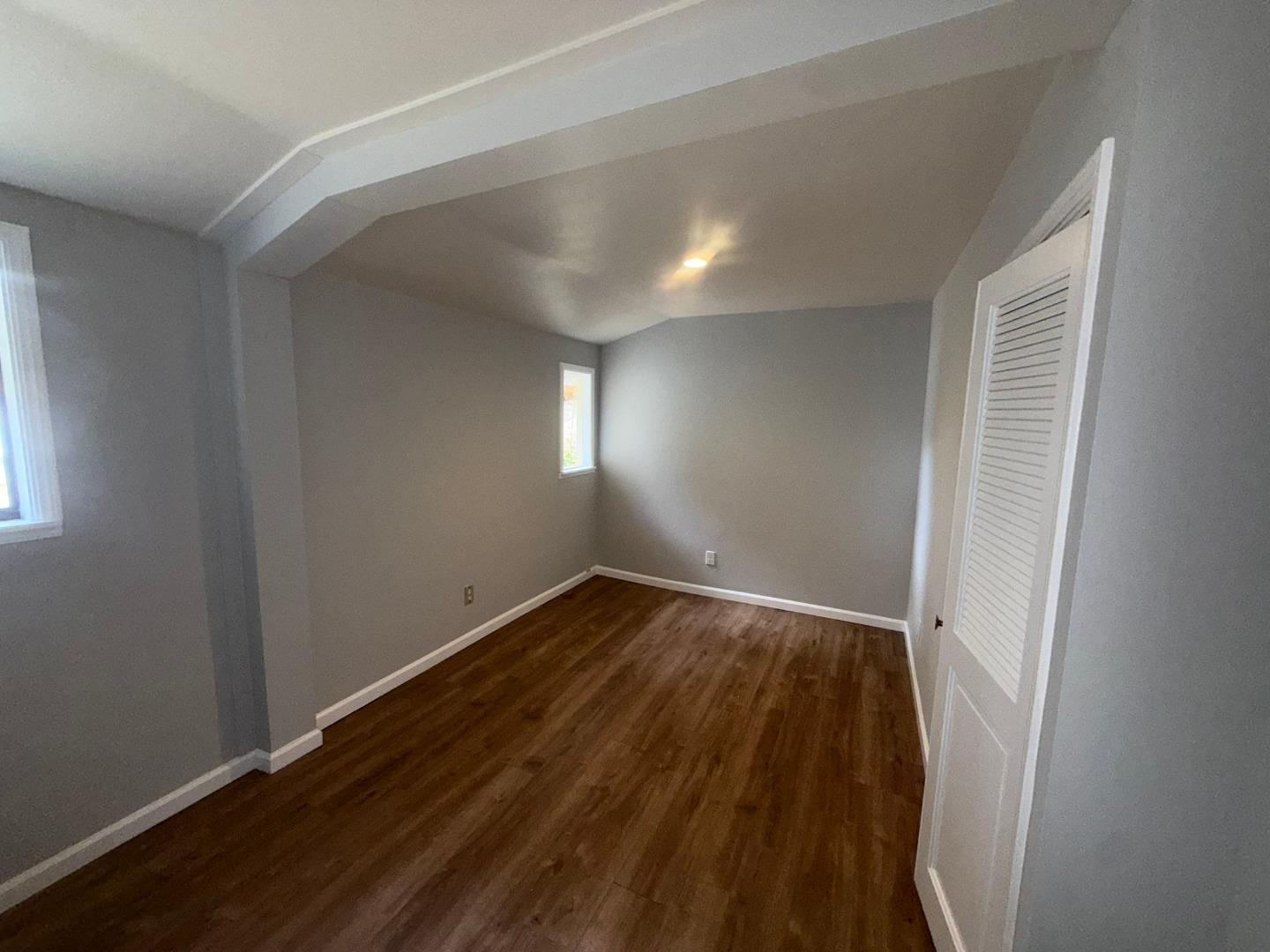 11585 McCarthy Road Carmel Valley, CA 93924 - Photo 47 of 52 an empty room with wooden floor and windows