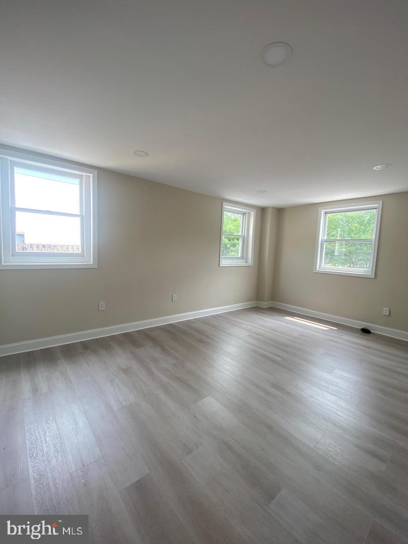 1207 County Line Road Bryn Mawr, PA 19010 - Photo 11 of 17 an empty room with wooden floor and windows