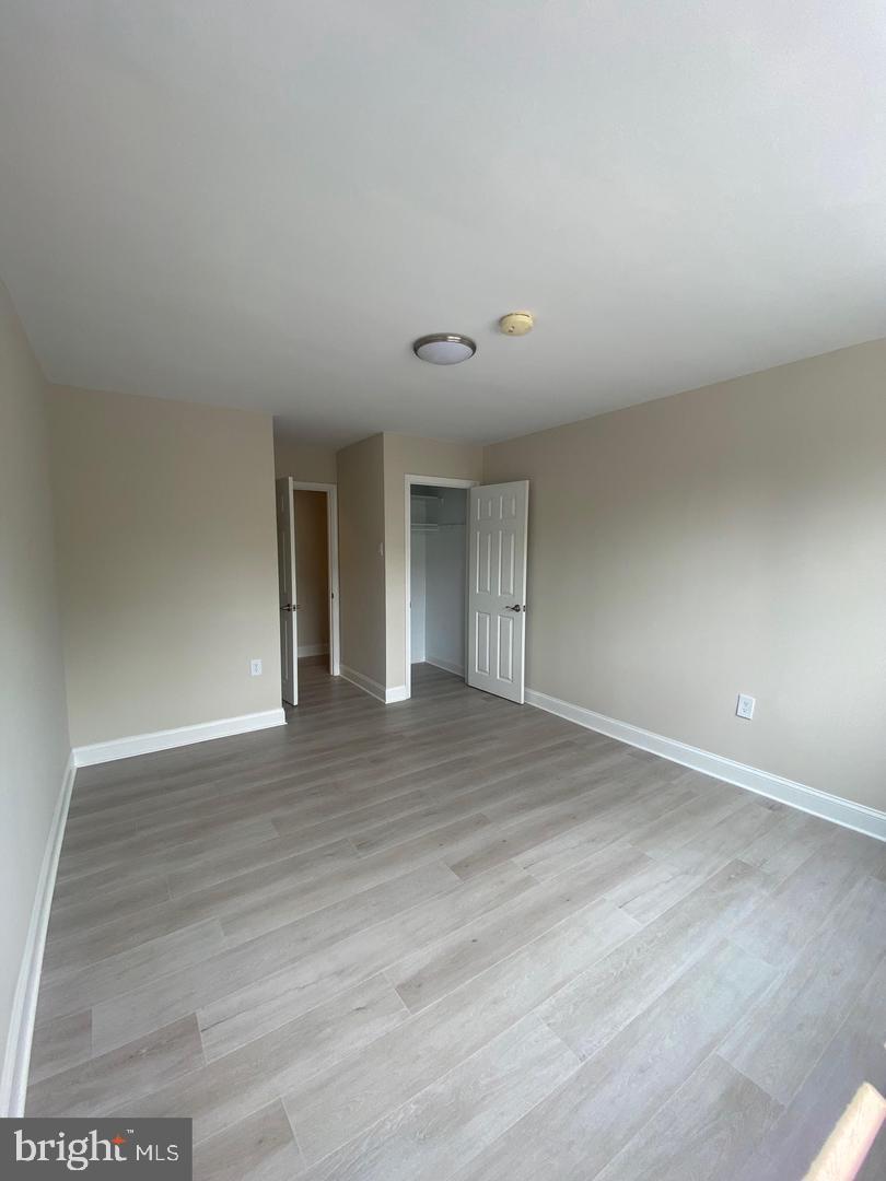 1207 County Line Road Bryn Mawr, PA 19010 - Photo 13 of 17 a view of an empty room with wooden floor and a window