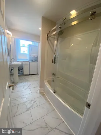 a bathroom with a bathtub a toilet and a shower