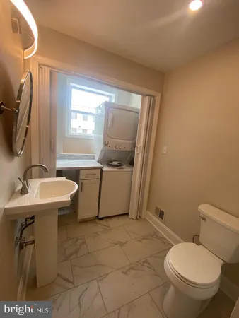 a bathroom with a sink toilet and mirror