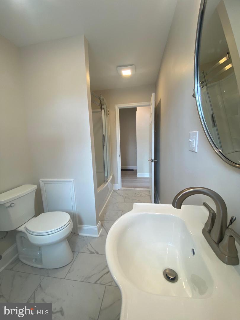 1207 County Line Road Bryn Mawr, PA 19010 - Photo 10 of 17 a bathroom with a sink and a mirror
