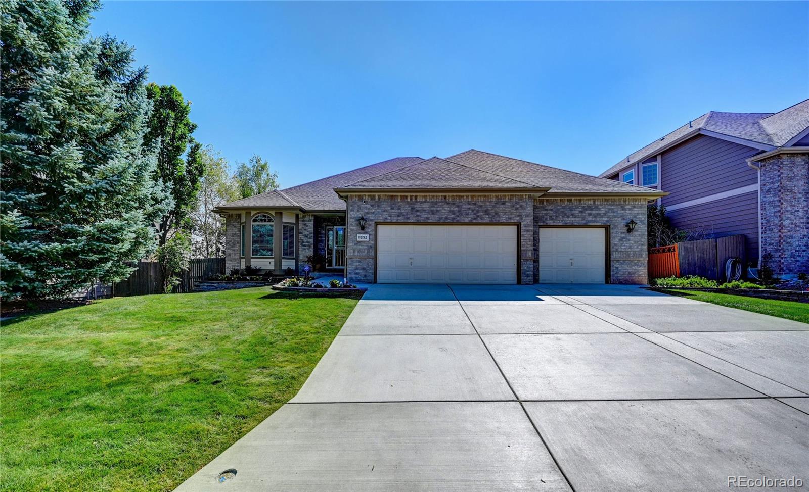 11232 West Cooper Drive Littleton, CO 80127 - Photo 1 of 48 a front view of a house with yard and green space