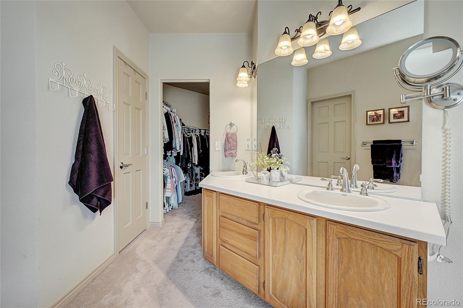 11232 West Cooper Drive Littleton, CO 80127 - Photo 22 of 48 a bathroom with a sink vanity and a mirror