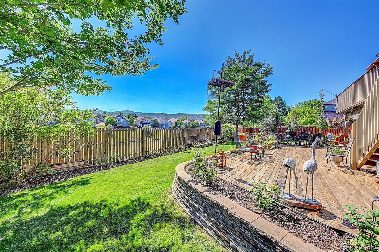 11232 West Cooper Drive Littleton, CO 80127 - Photo 33 of 48 a view of a backyard with sitting area