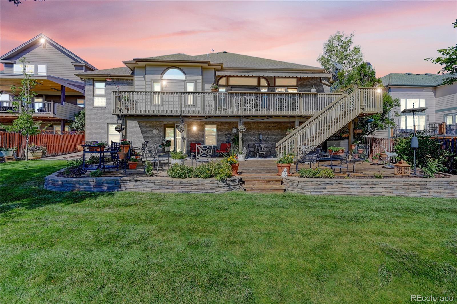 11232 West Cooper Drive Littleton, CO 80127 - Photo 36 of 48 a front view of a building with garden and trees