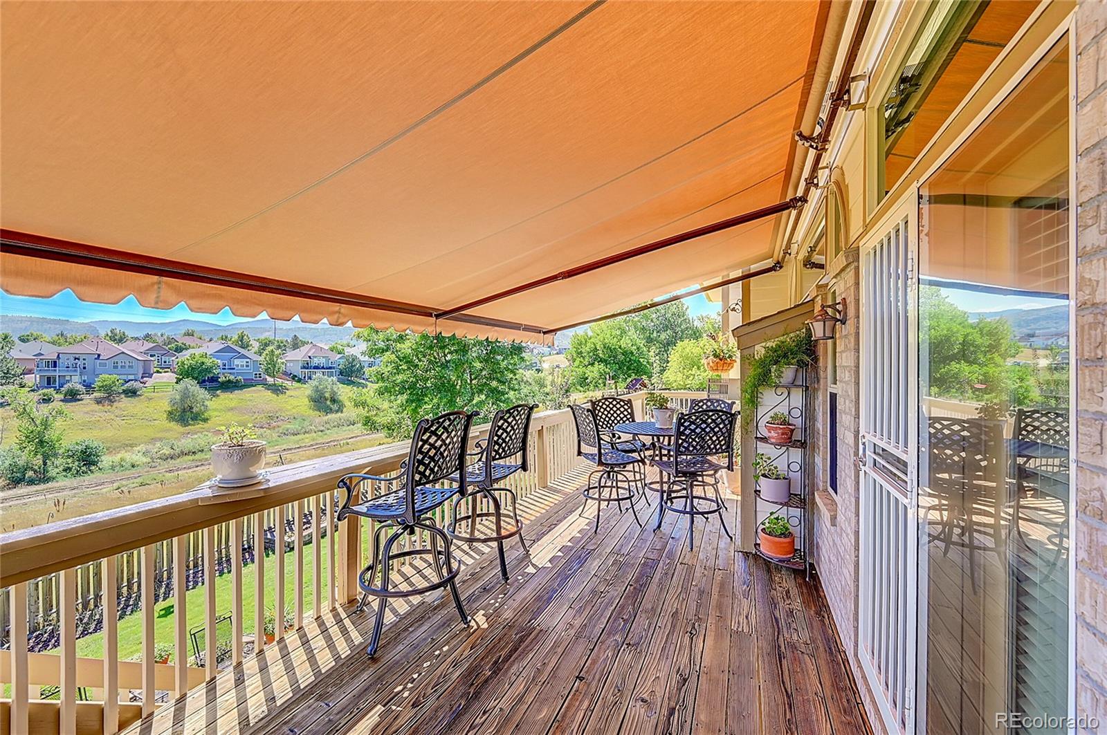 11232 West Cooper Drive Littleton, CO 80127 - Photo 40 of 48 a view of a balcony with chairs and wooden floor