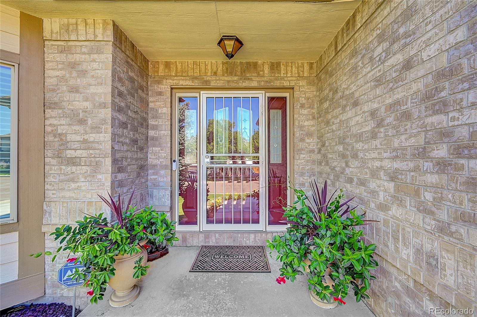 11232 West Cooper Drive Littleton, CO 80127 - Photo 4 of 48 a front view of a house with plants