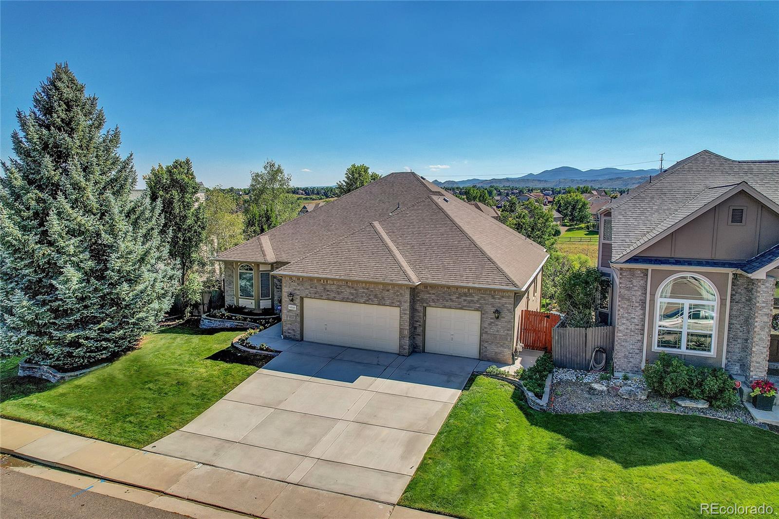 11232 West Cooper Drive Littleton, CO 80127 - Photo 43 of 48 a front view of a house with a yard and garage