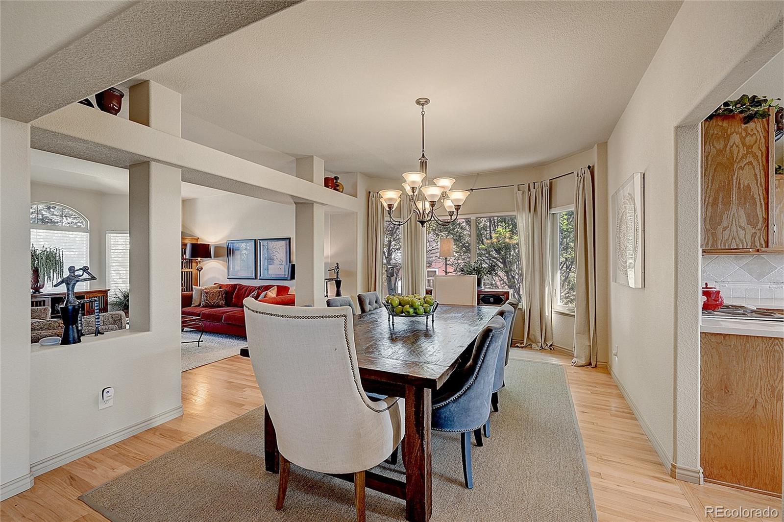 11232 West Cooper Drive Littleton, CO 80127 - Photo 10 of 48 a view of a dining room with furniture and chandelier