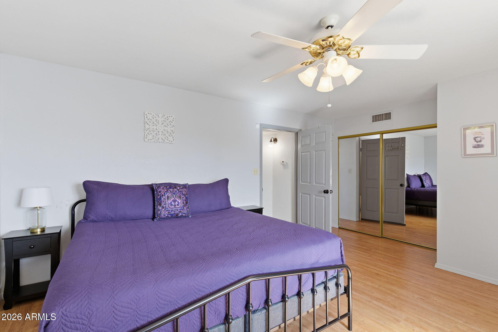 4218 West Boca Raton Road Phoenix, AZ 85053 - Photo 12 of 27 a bedroom with a bed and a chandelier