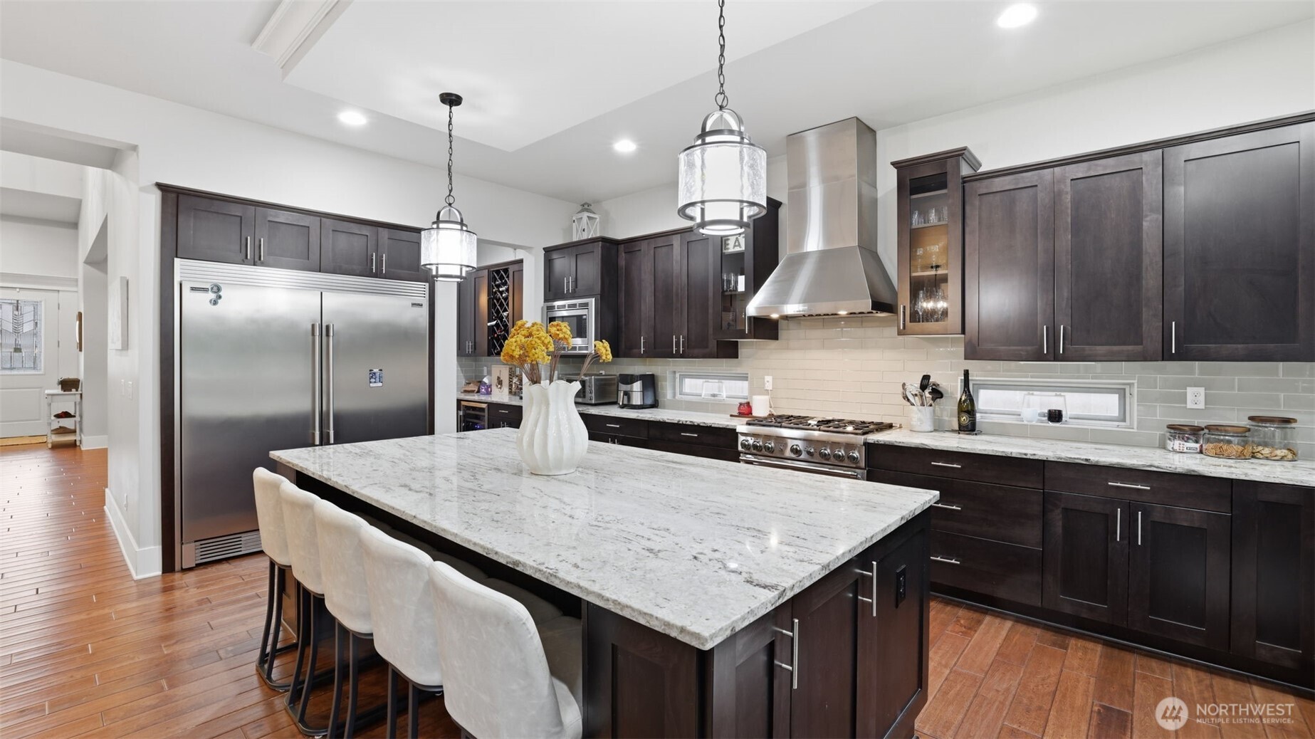 6508 Southeast 7th Place Renton, WA 98059 - Photo 11 of 32 a kitchen with stainless steel appliances granite countertop a sink a stove a refrigerator and island