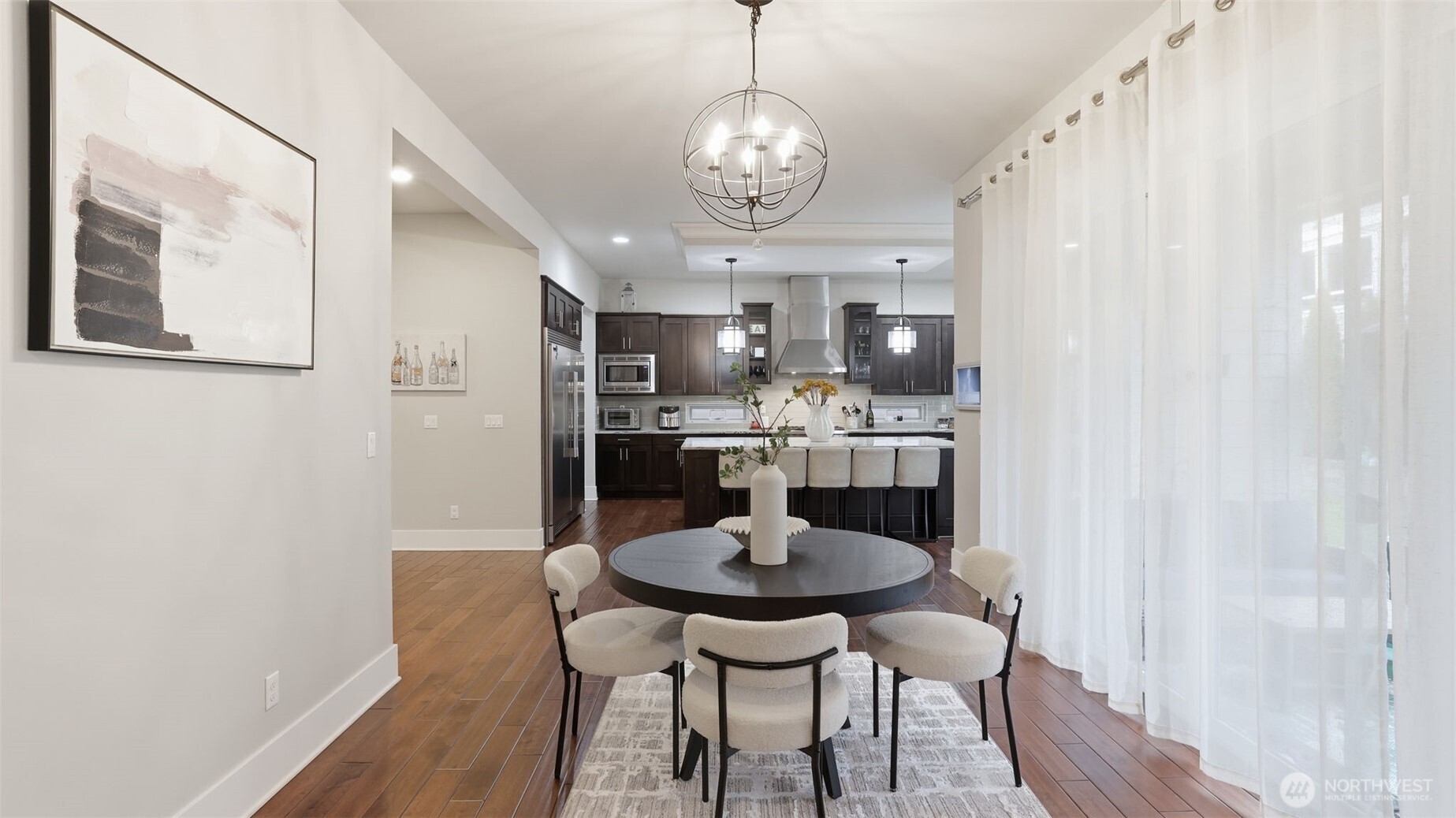 6508 Southeast 7th Place Renton, WA 98059 - Photo 12 of 32 a view of a dining room with furniture wooden floor and a chandelier