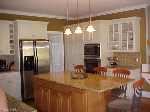 5705 Cape Fox Drive Oak Ridge, NC 27310 - Photo 4 of 8 Other. Kitchen with island/Bar, granite countertops, hardwood floors, built in MW and Oven.