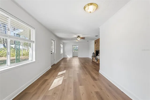 a view of empty room with wooden floor
