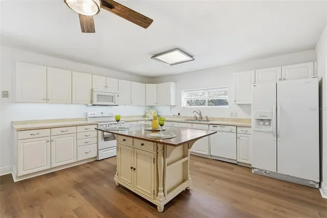 a kitchen with stainless steel appliances granite countertop a sink and cabinets