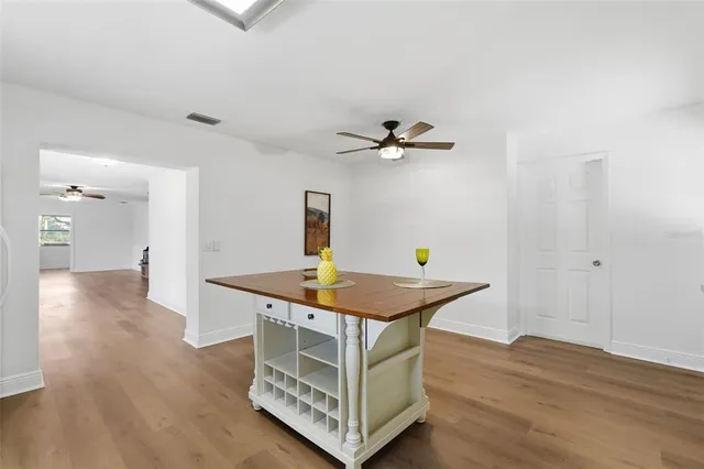 a kitchen with stainless steel appliances granite countertop a sink and a wooden floor