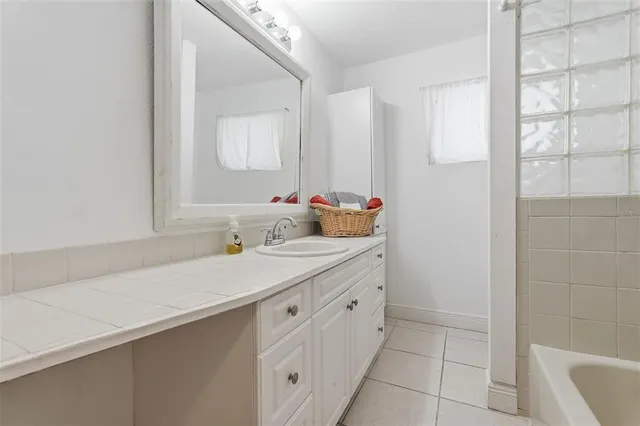 a bathroom with a sink and a mirror