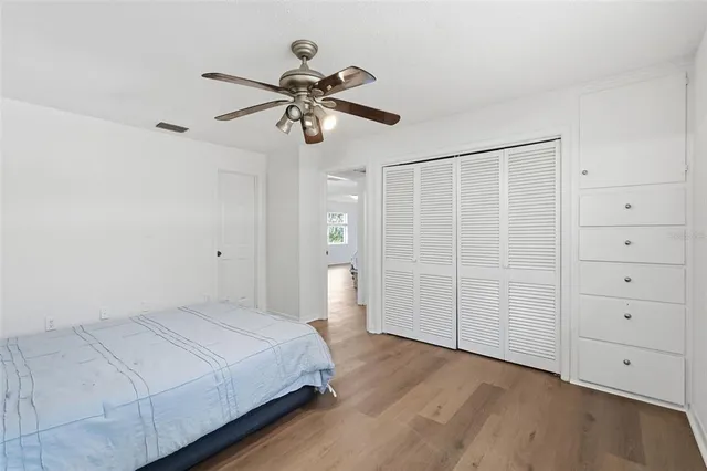 a bedroom with a large bed and a chandelier