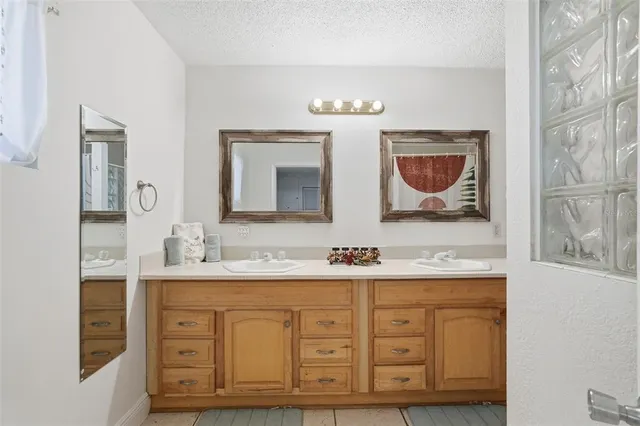 a bathroom with a double vanity sink double and mirror