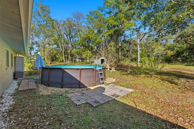 a view of a house with backyard and sitting area