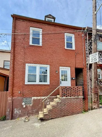 a front view of a house with parking