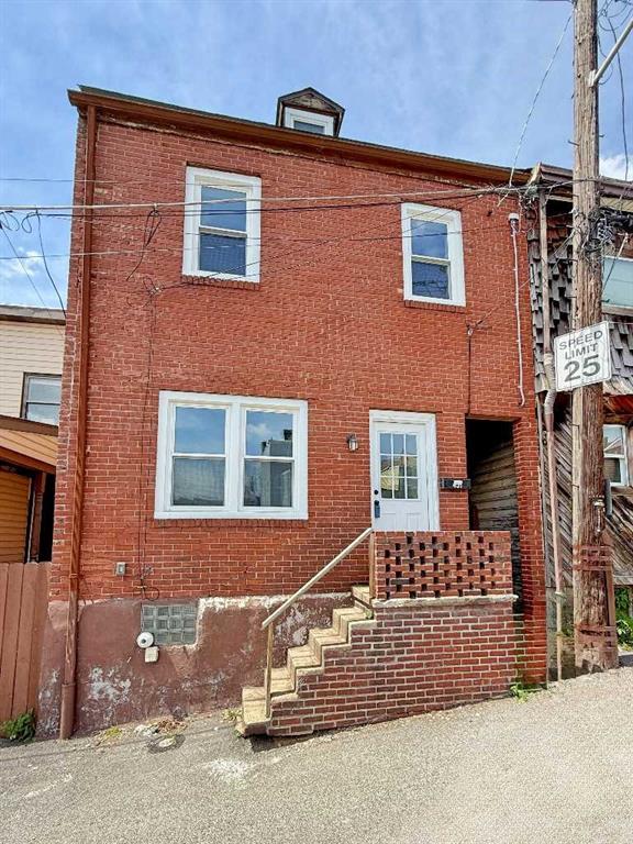 a front view of a house with parking