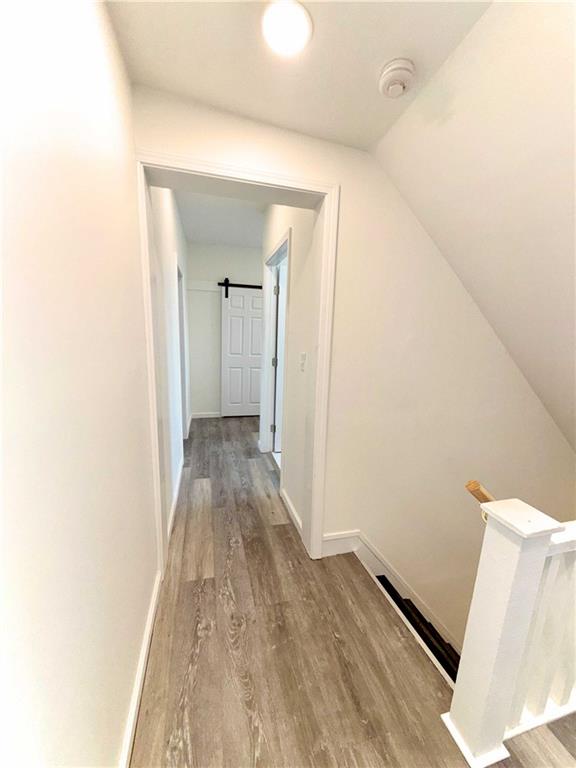 437 Sapphire Way Pittsburgh, PA 15224 - Photo 13 of 20 a view of a hallway with wooden floor and a bathroom