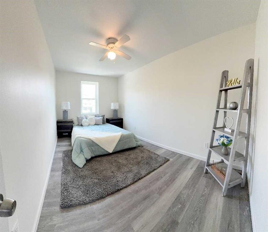 437 Sapphire Way Pittsburgh, PA 15224 - Photo 16 of 20 a bedroom with a bed and wooden floor