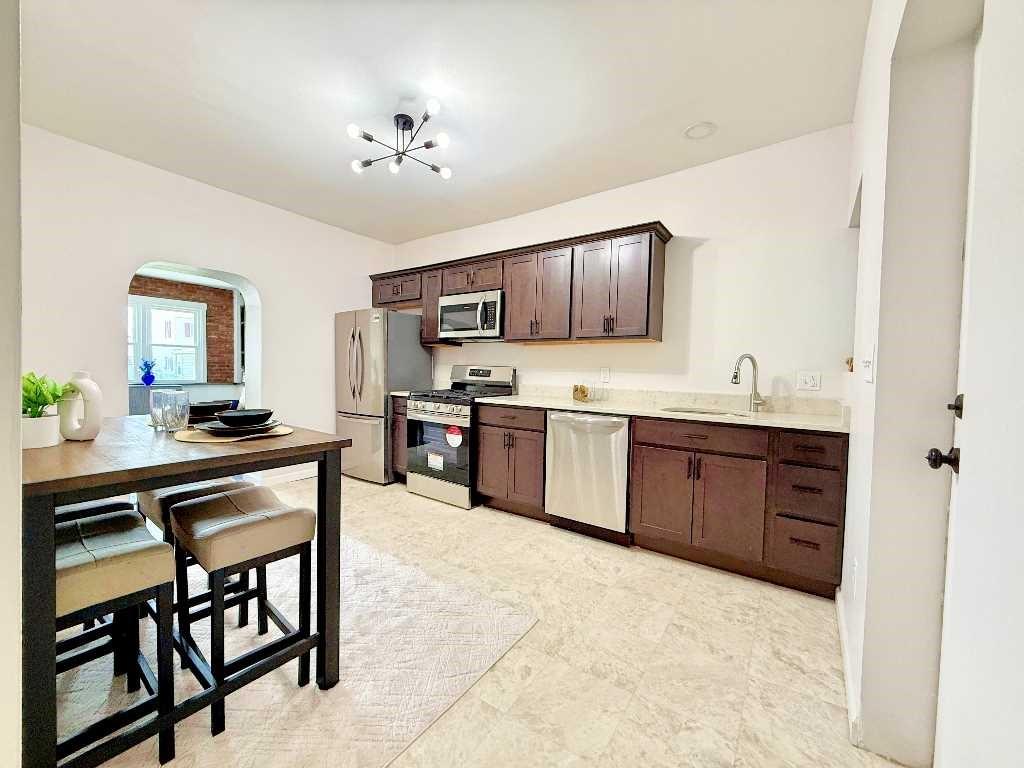 437 Sapphire Way Pittsburgh, PA 15224 - Photo 5 of 20 a kitchen with a sink stove and microwave