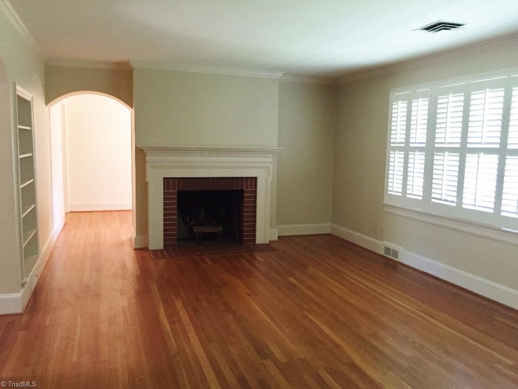 3030 University Road Winston-Salem, NC 27104 - Photo 2 of 15 Living room with masonry fireplace and built in shelves