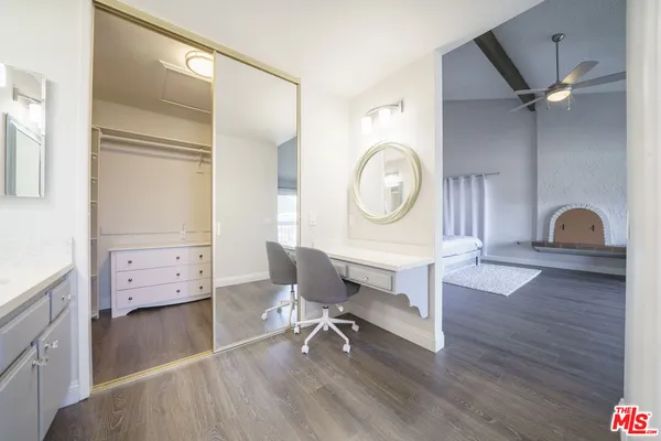 a view of a workspace with furniture and a window